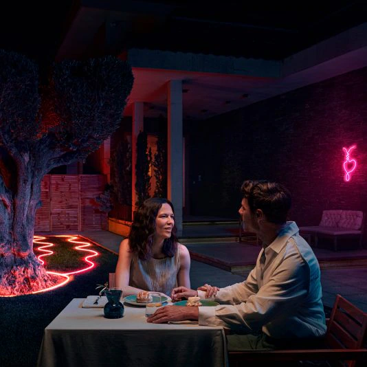 Luxury swimming pool with underwater Philips Hue smart lights and deck accent lighting at night